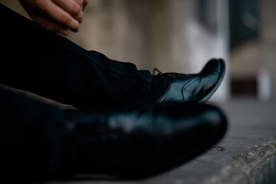 Low section of man sitting on floor