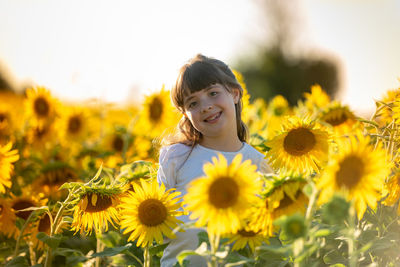 Portrait of girl on sunflower field
