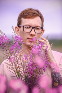 Portrait of man with pink flowers