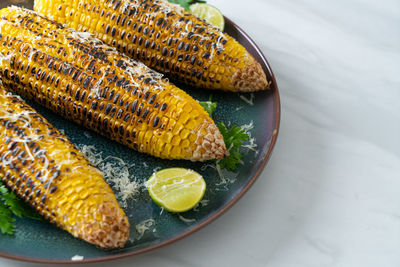 High angle view of corns in plate on table