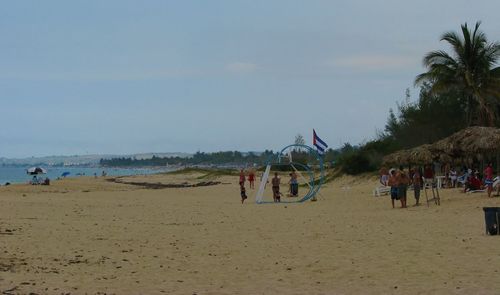 People on beach against sky