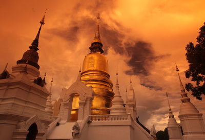 Low angle view of wat suan dok against sky during sunset