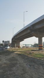 Road by bridge against clear sky