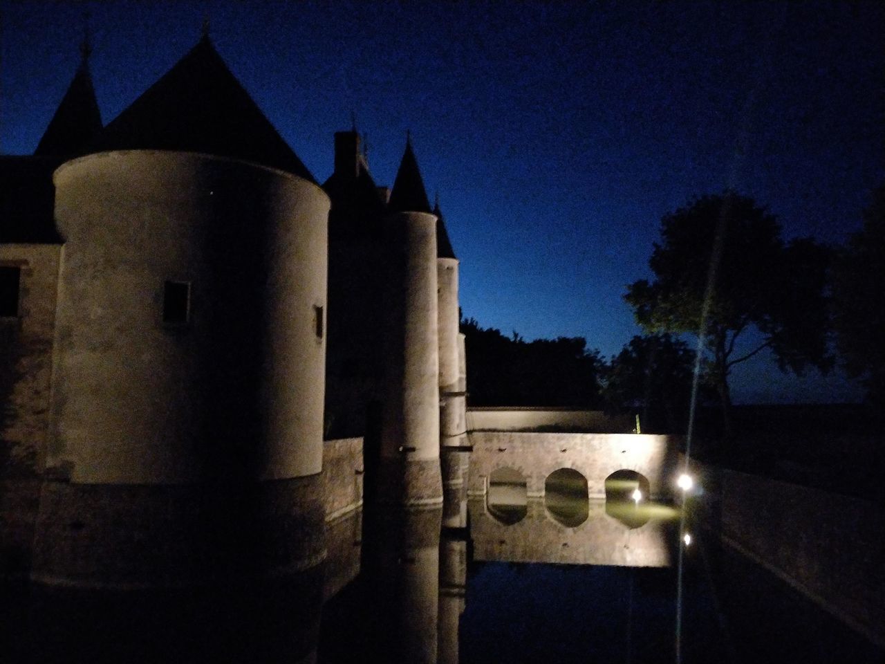 BUILDING AGAINST SKY AT NIGHT