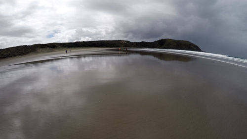 Scenic view of lake against cloudy sky