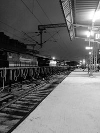 Illuminated railroad station platform at night