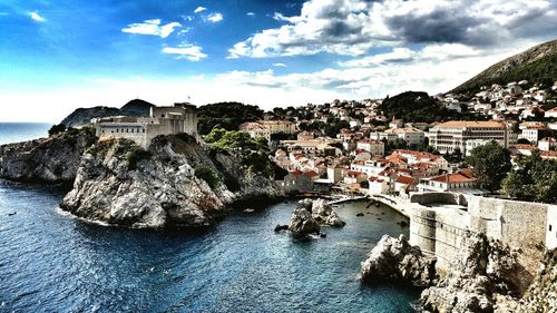 Town against cloudy sky