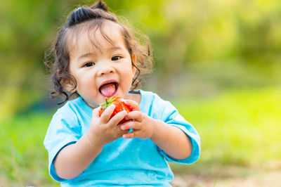 Portrait of cute girl holding food