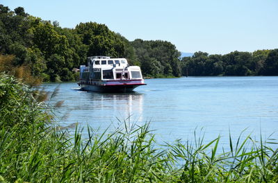 Boat in river against sky