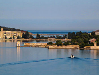 Boat leaving the port of pula early in the morning