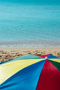 Scenic view of beach against blue sky