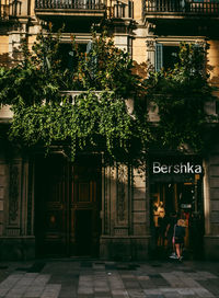 People at entrance of building in city