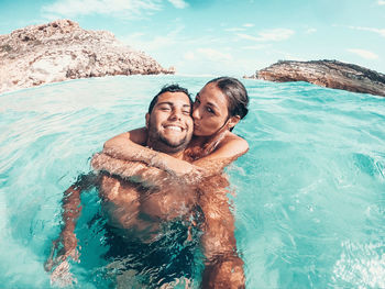 Portrait of happy young man in sea