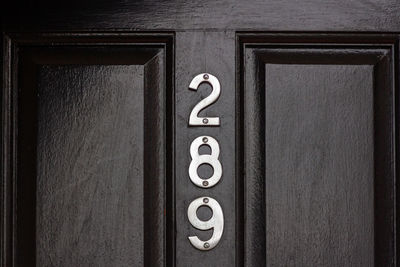 Close-up of text on wooden door