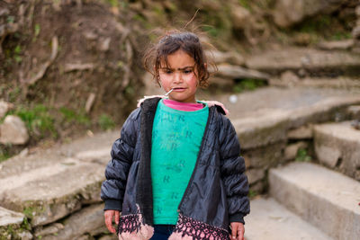 Portrait of teenage girl standing outdoors