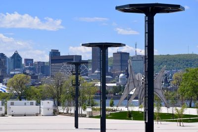 Street light by buildings against sky