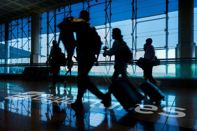 People walking to gate departure of flight. tourists with luggage. travel, tourism, journey concept