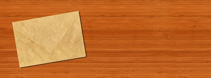 High angle view of paper on wooden table