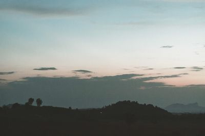 Scenic view of silhouette landscape against sky at sunset
