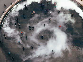 High angle view of people at town square during foggy weather