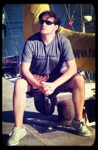 Young man sitting in sunglasses