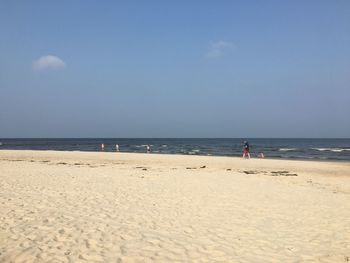 Scenic view of beach against blue sky