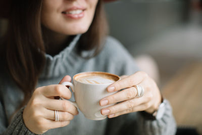 Close-up of woman holding coffee cup