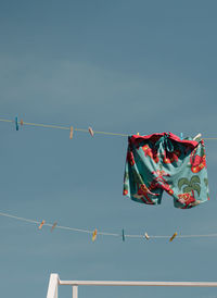 Low angle view of flags against sky