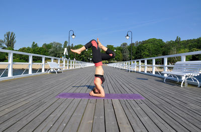 Rear view of man standing on bridge