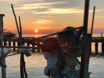 Close-up of fishing net on railing against river