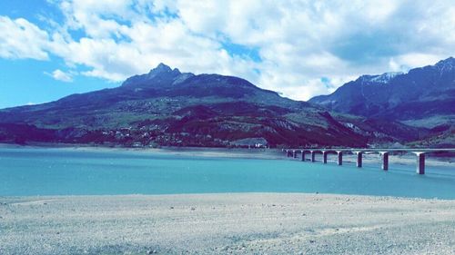 Scenic view of lake and mountains against sky