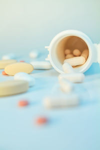 Close-up of medicines with bottle on table