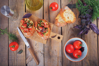 Italian bruschetta with chopped tomatoes, basil, herbs and olive oil on grilled crusty bread