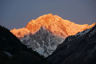 Scenic view of snowcapped mountains against clear sky