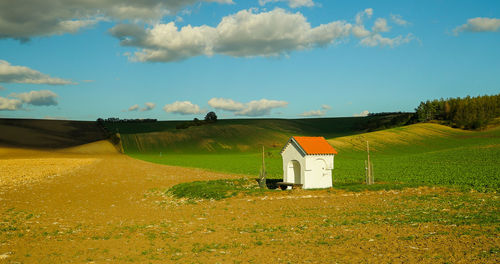 Houses on field against sky