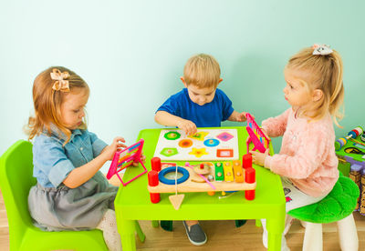 Bother and sisters playing at home