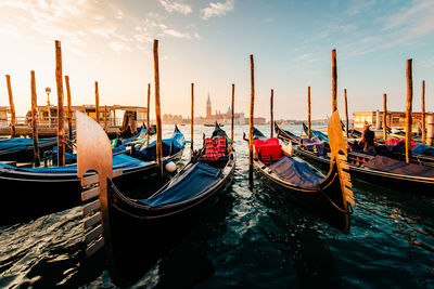 Close up of moored gondolas with giudecca island in the background