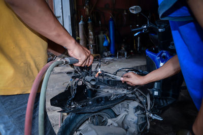 Midsection of man working in workshop