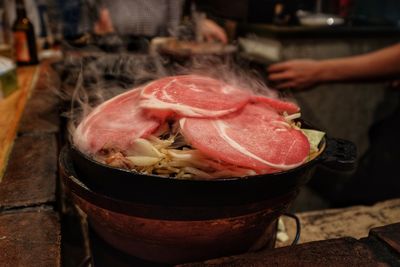 Close-up of person preparing food on table