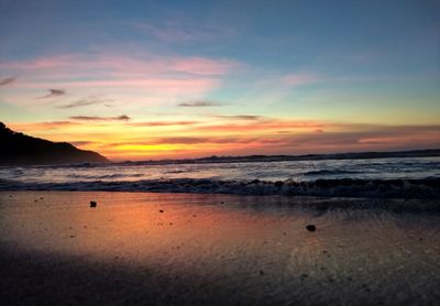 Scenic view of sea against sky at sunset