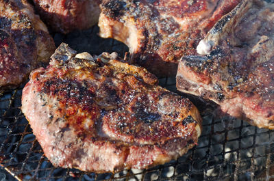 High angle view of meat on barbecue grill