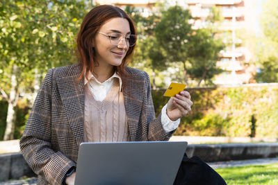 Portrait of young woman using digital tablet