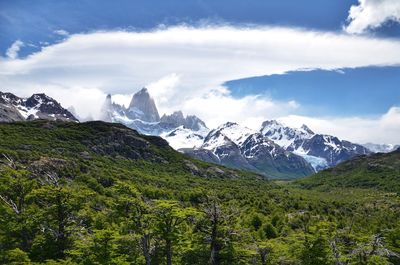 Scenic view of mountains against cloudy sky