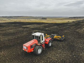 High angle view of tractor on field against sky