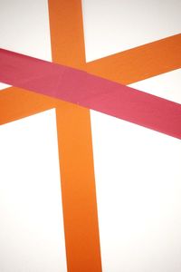 Low angle view of orange wall against sky