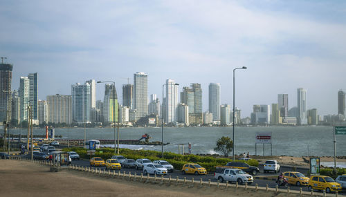 View of cityscape against cloudy sky