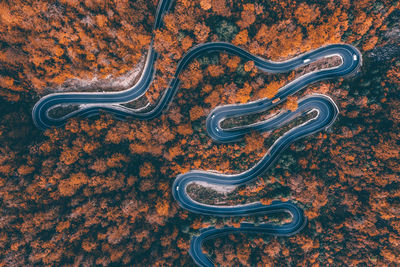 Aerial view of road amidst forest during winter