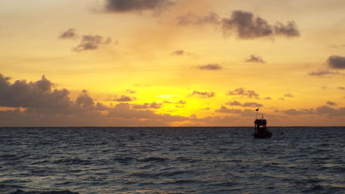Scenic view of sea against orange sky