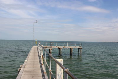 Wooden jetty leading to calm sea