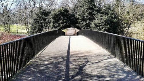 Narrow walkway leading to footbridge